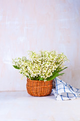 Lily of the valley on white wooden background