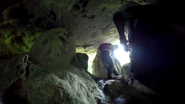 Cave explorers adventuring through cave