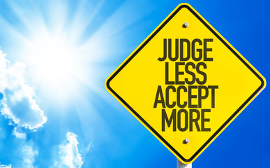 Judge Less Accept More sign with sky background