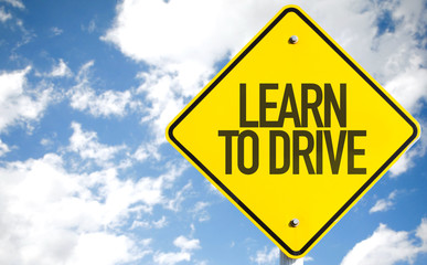 Learn To Drive sign with sky background