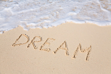 Fototapeta premium Word DREAM on beach - vacation concept background
