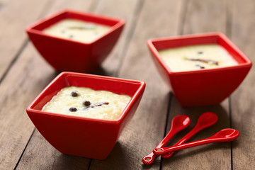 Ecuadorian dessert called morocho (coarsely ground white corn) cooked with milk, sugar and spices (Selective Focus, Focus on the middle of the lower morocho)