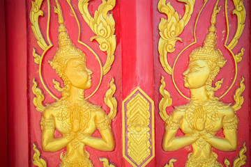 The ramayana epic carved on a wood door inside a temple.They are