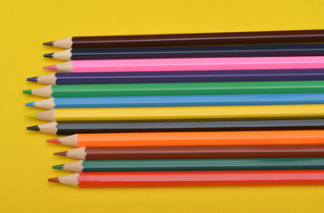 Set of Colorful Pencils on Yellow Background