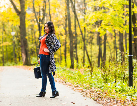  girl student  walking in the autumn park