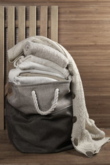 Stacked sweaters in fabric basket