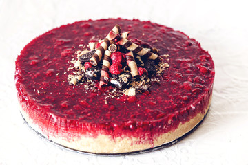 Biscuits cheesecake with raspberries and wafer sticks