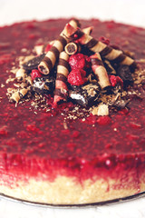 Biscuits cheesecake with raspberries and wafer sticks