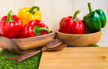 sweet peppers on wooden table background