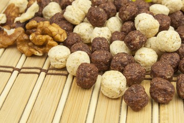 Chocolate cereal balls in a bowl of bamboo. Healthy breakfast with fruit and milk. A diet full of energy and fiber for athletes. Quick to prepare homemade breakfast.
