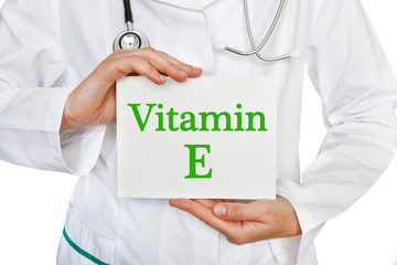 The female doctor, with the plate Vitamin E,  medical concept