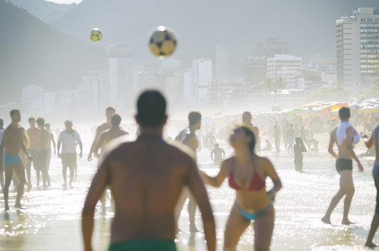 Brazilian men and women play keepy uppy on the shore of Ipanema Beach at Posto 9, a famous gathering place for the game, called altinho.