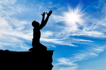 Silhouette of man praying