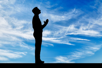Silhouette of man praying