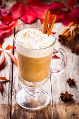pumpkin latte with whipped cream in a glass jar