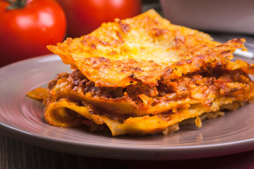 Piece of tasty hot lasagna on a plate