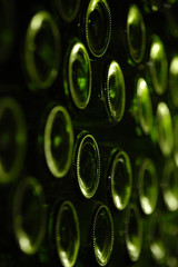 close up of wine bottles in rack