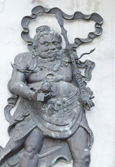 chines statue on door of temple at nontaburi, Thailand.