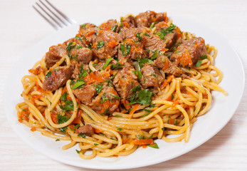 Pieces of meat and vegetables with spaghetti