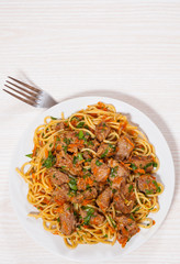 Pieces of meat and vegetables with spaghetti