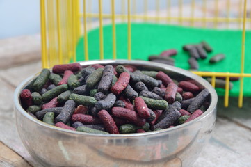 rabbit food in bowl and yellow cage