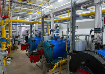 Place in a large industrial boiler room. 