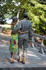 Romantic couple outdoors, he is a soldier