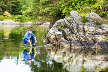 Troldhaugen. Reflection of a young man in the lake, where is located the manor of Edvard Grieg.