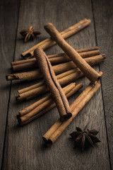 Cinnamon stick and star anise spice on rustic wood table  backgr