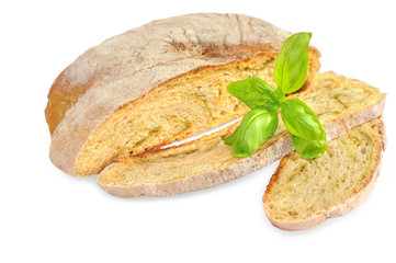 Sliced wheat bread and  basil on white.