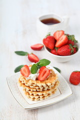 Waffles and ripe strawberries.