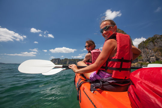 Caucasian woman is kayaking in sea at Thailand
