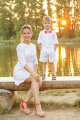 Fototapeta premium Mother and child play in autumn park