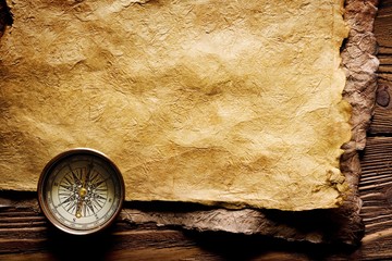 Close up view of the Compass on the old paper background - obrazy, fototapety, plakaty