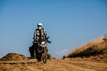 Motorbiker travelling in autumn mountains