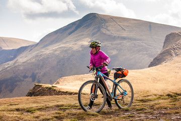 Fototapeta premium Biker riding in autumn mountains
