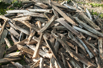 Pile of weathered firewood stacked randomly as background