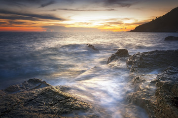 long exposure of sea and rocks and stones, teal tone