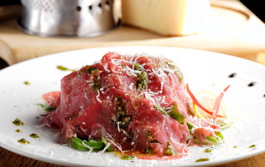 Fine dining, Beef carpaccio with pesto genovese, parmesan cheese, capers and rocket salad