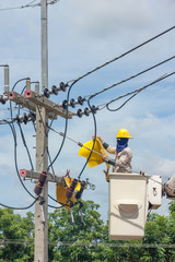 electrical utility worker in a bucket fixes a problem with a pow