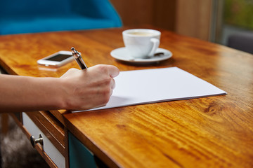 Woman writing in cafe