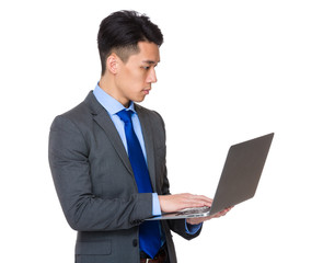 Young businessman use of the notebook computer