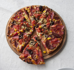 Delicious pizza served on wooden table