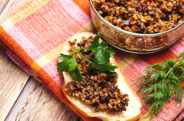 sandwich from mushroom caviar decorated with greens