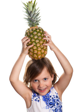 little girl with a pineapple on his head