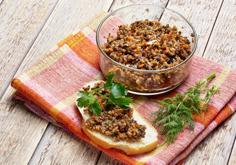 sandwich from mushroom caviar decorated with greens