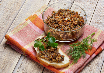 sandwich from mushroom caviar decorated with greens