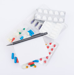 Tablets, capsules in blister packs and ballpoint pen with blank