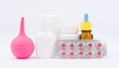 Enema and pills in blister packs with bottles of medicine