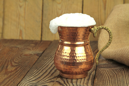 Ayran - Traditional Turkish yoghurt drink in a copper metal cup
